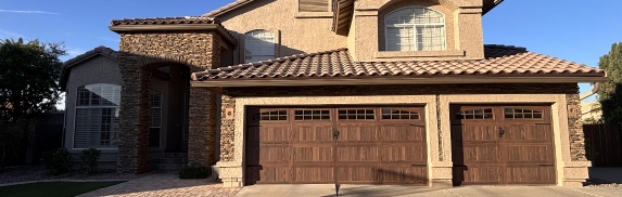 Two-story residential exterior with architectural stone columns