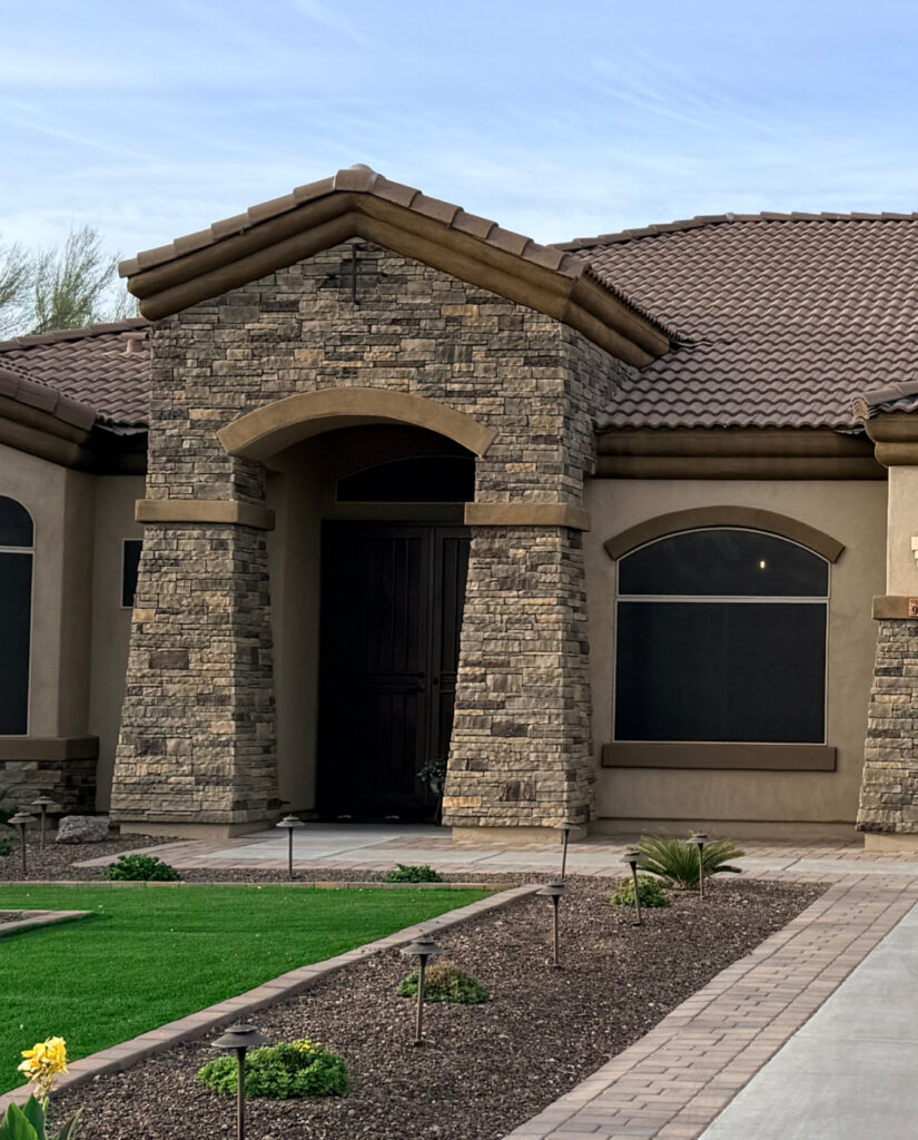 Manufactured stone veneer installed on a home entry and facade